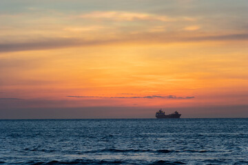 Naklejka na ściany i meble oil tanker ship at sunset in the sea