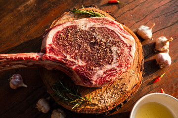 Sliced grilled thai steak served on white plate with grilled sliced lemon, tomatoes, garlic