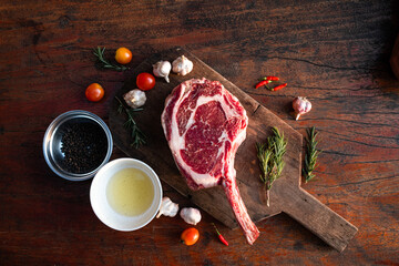 Sliced grilled thai steak served on white plate with grilled sliced lemon, tomatoes, garlic