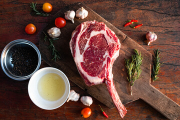 Sliced grilled thai steak served on white plate with grilled sliced lemon, tomatoes, garlic