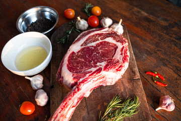 Sliced grilled thai steak served on white plate with grilled sliced lemon, tomatoes, garlic