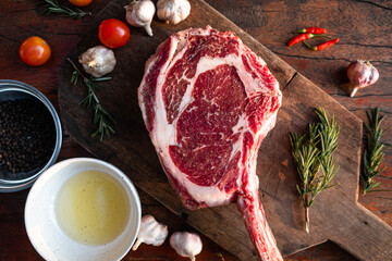 Sliced grilled thai steak served on white plate with grilled sliced lemon, tomatoes, garlic