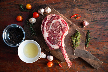 Sliced grilled thai steak served on white plate with grilled sliced lemon, tomatoes, garlic