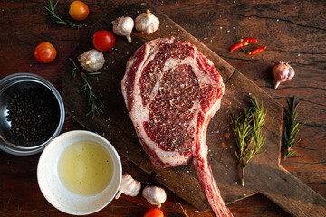 Sliced grilled thai steak served on white plate with grilled sliced lemon, tomatoes, garlic