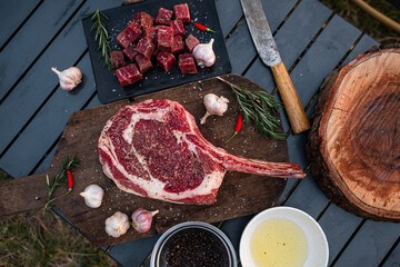 Sliced grilled thai steak served on white plate with grilled sliced lemon, tomatoes, garlic