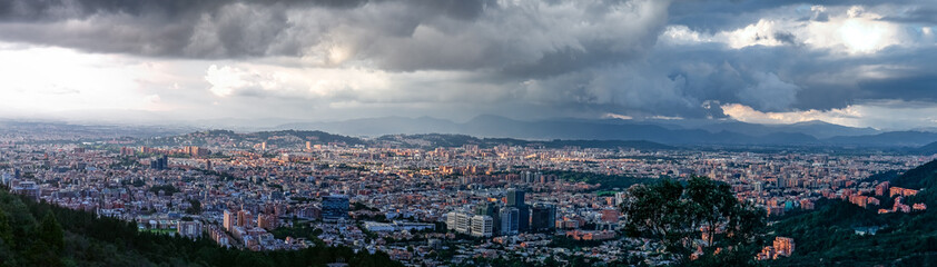 Fototapeta na wymiar Panorama of the high plateau with the Colombian capital Bogota with dramatic cloudy sky and sunlight