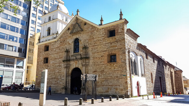 Historic church San Augustin in Bogotá, capital of Colombia, in background a modern building
