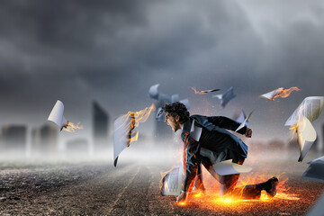Determined businessman leaving fire trails on asphalt