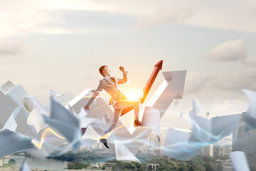 Portrait of energetic businessman jumping in open air