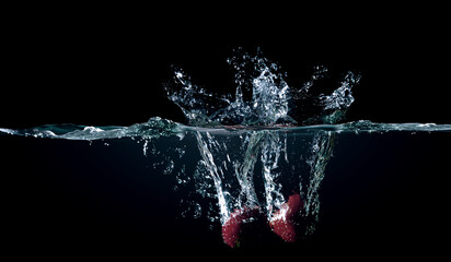 Red pepper in water with splashes