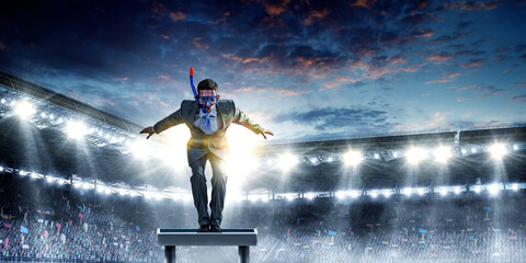 Young businessman in suit ready to dive