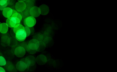 Abstract blur image of green light of beautiful bokeh on black background with copy space. Blurred...