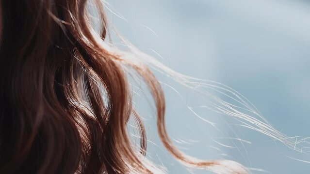 Woman With Curly Red Hair Waved By Light Wind At Sunlight