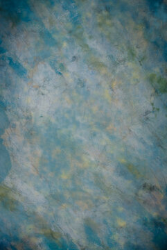 Canvas cloth or muslin photography studio background or backdrop. Classic painted strokes technique, stormy paintbrush strokes in shades of blue, green, light yellow and white