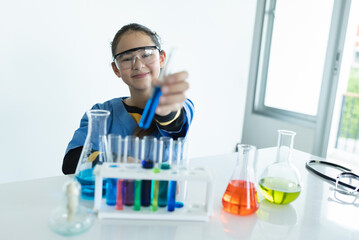 Portrait girl kids study science with test chemical in glassware	