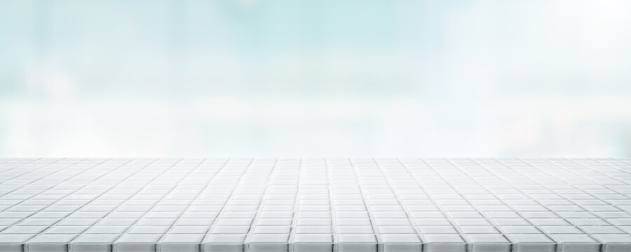 Empty white ceramic mosaic table top and blurred bokeh background - can used for display or montage your products.