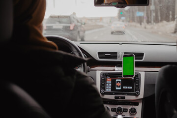 Millennial man drive the car and using mobile app , green screen
