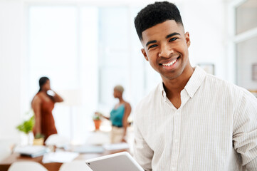 Technology thats as innovative as his designs. Portrait of a young businessman using a digital tablet in a modern office.