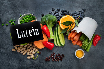 Foods high in lutein on dark background.