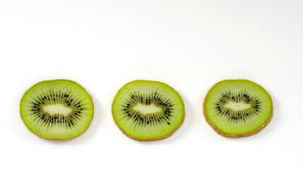 Fototapeta premium kiwi slices on a white surface, background, banner