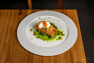 Salmon steak fillet with broccoli puree, kale, feta mousse and red caviar