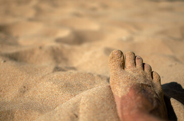 wet feet of a man on a sandy beach