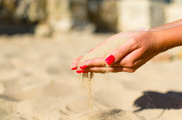 sand through fingers on the beach