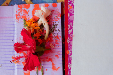 New accounts book opened to start writing in new year, are being worshipped on auspicious day of Bengali new year, called nabobarsho. Holy hibiscus flower,red sign of painted coin as per Hindu ritual.