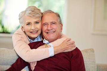 Everything is better when were together. Shot of a senior woman embracing her husband from behind.