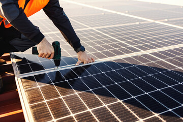 Close up of a handyman installing solar panels on the roof.