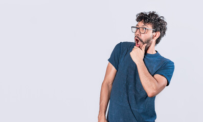 Amazed young man with hand near open mouth, man looking aside with face scared expression, surprised guy on isolated background