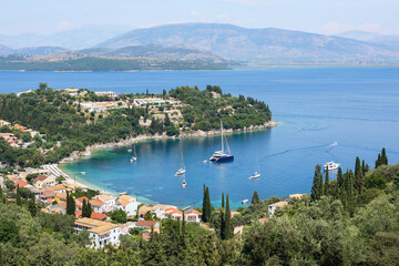 Fototapeta premium Beautiful bay with beach in Kalami village, Corfu island, Greece. Panoramic top view of beautiful mediterranean landscape