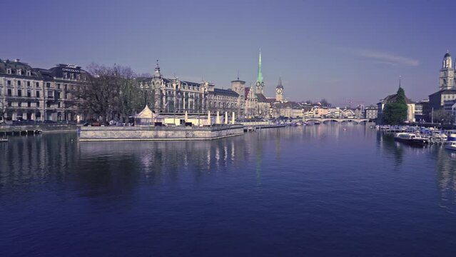 Panoramic view of City of Z&uuml;rich with river Limmat and cityscape of the medieval old town on a sunny spring day. Movie shot March 3rd, 2022, Zurich, Switzerland.