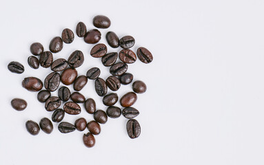 Roasted coffee beans with shiny skin It has been carefully selected. Ready to grind and bring to the brew Taken from a high angle with the aroma of coffee. on a white background in the studio