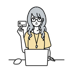 デスクで座ってPCを使いながらクレジットカードを手に持っている教師の女性