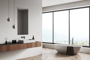 Corner view on bright bathroom interior with bathtub, panoramic window