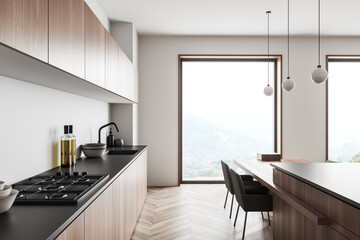 Kitchen interior with seats and countertop, kitchenware and panoramic window