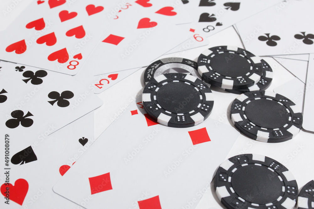 Wall mural poker chips and playing cards on a white background