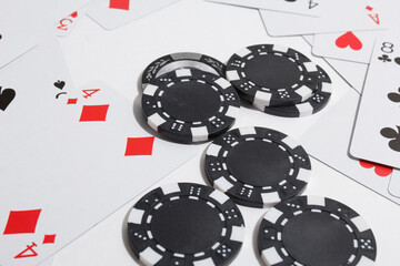 poker chips and playing cards on a white background