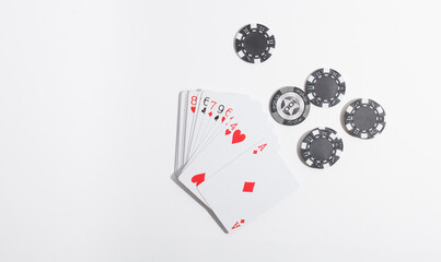 poker chips and playing cards on a white background