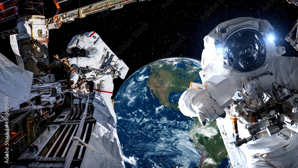 Wall mural astronaut spaceman do spacewalk while working for spaceflight mission at space station . astronaut w