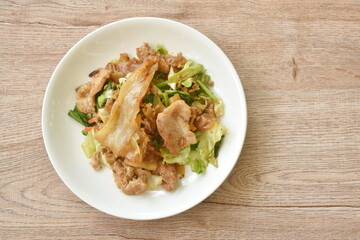 stir fried large rice noodles with slice fermenting pork and Chinese kale dressing black sweet soybean sauce on plate