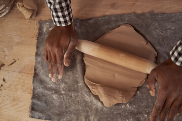 Professional potter working in his pottery studio