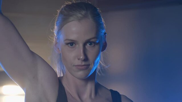 European Woman Doing Single-arm Dumbbell Snatch Workout At The Gym. close up