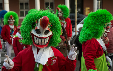 Mulhouse - France - 4 March 2022 - portrait of colorful masked people parading in the street