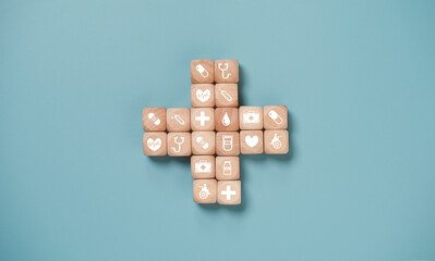 Wooden block cube which print screen health care and medical icons for healthy and wellness concept.