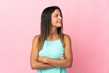 Obraz premium Caucasian girl isolated on pink background looking to the side