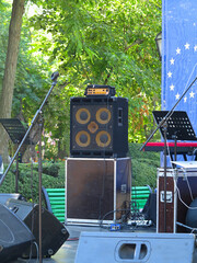 Concert stage: musical instruments, drums, amplifiers, speakers, microphones, cables
