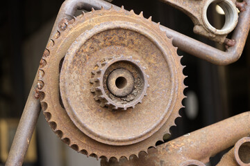 The gear wheel is covered with rust from an old gear. Close up view.