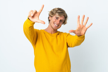 English man over isolated white background counting seven with fingers